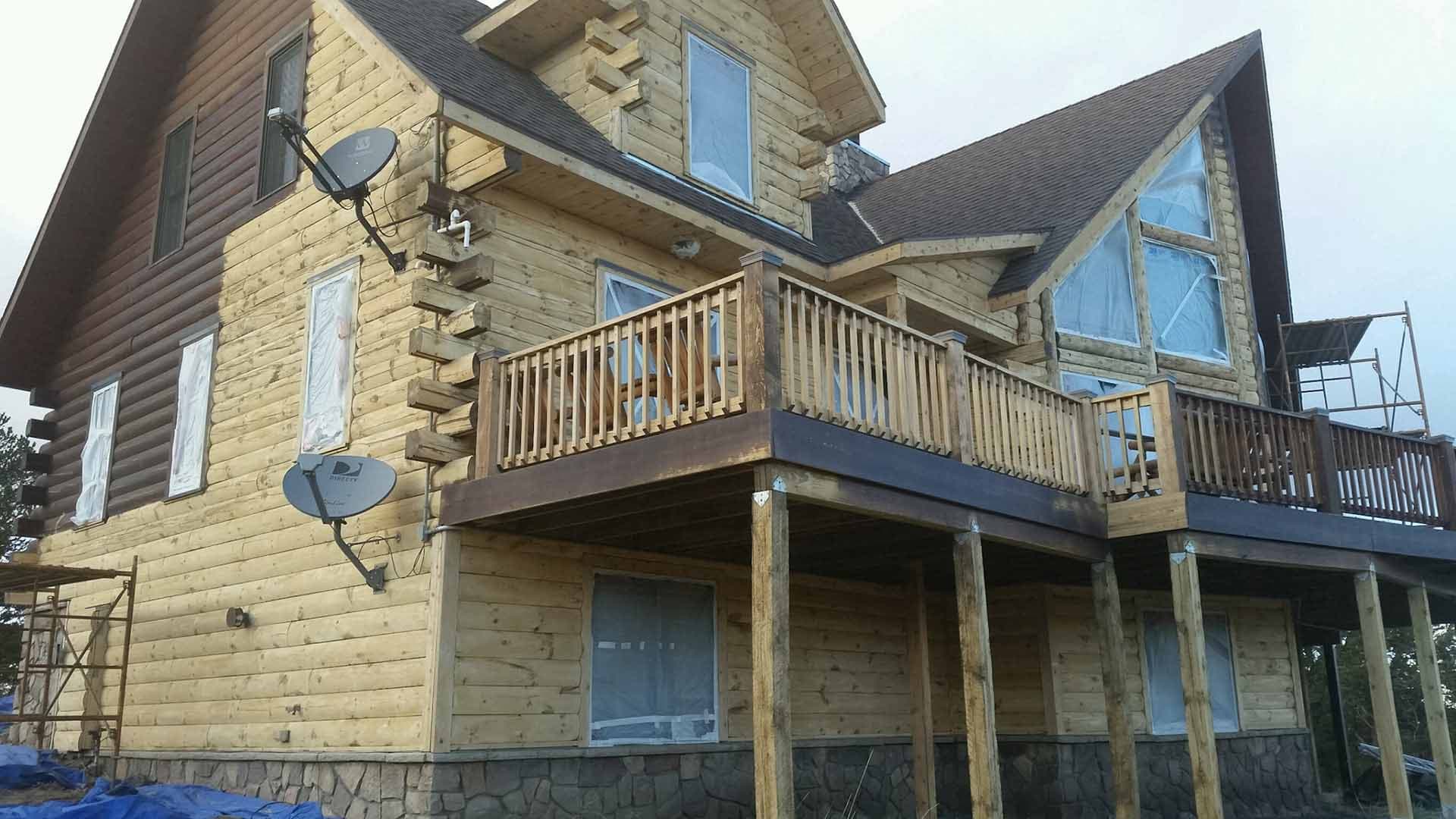 Media blasting equipment removing old stain from Park County Colorado log home during professional restoration process