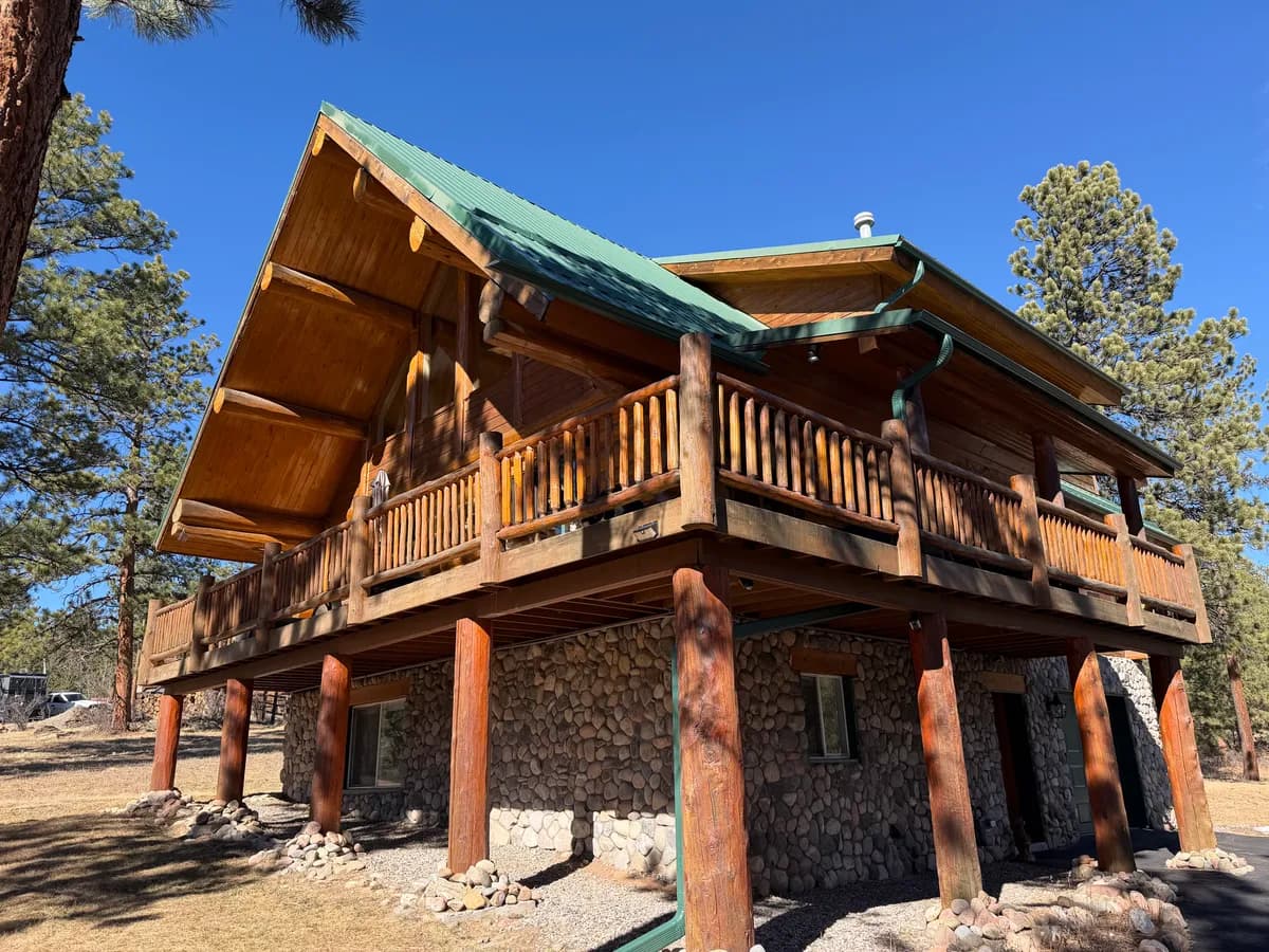 Log home before restoration in Bailey, Colorado - TJ's Log Home Full Restoration — Bailey, Colorado showing weathered logs, faded stain, and areas needing professional repair