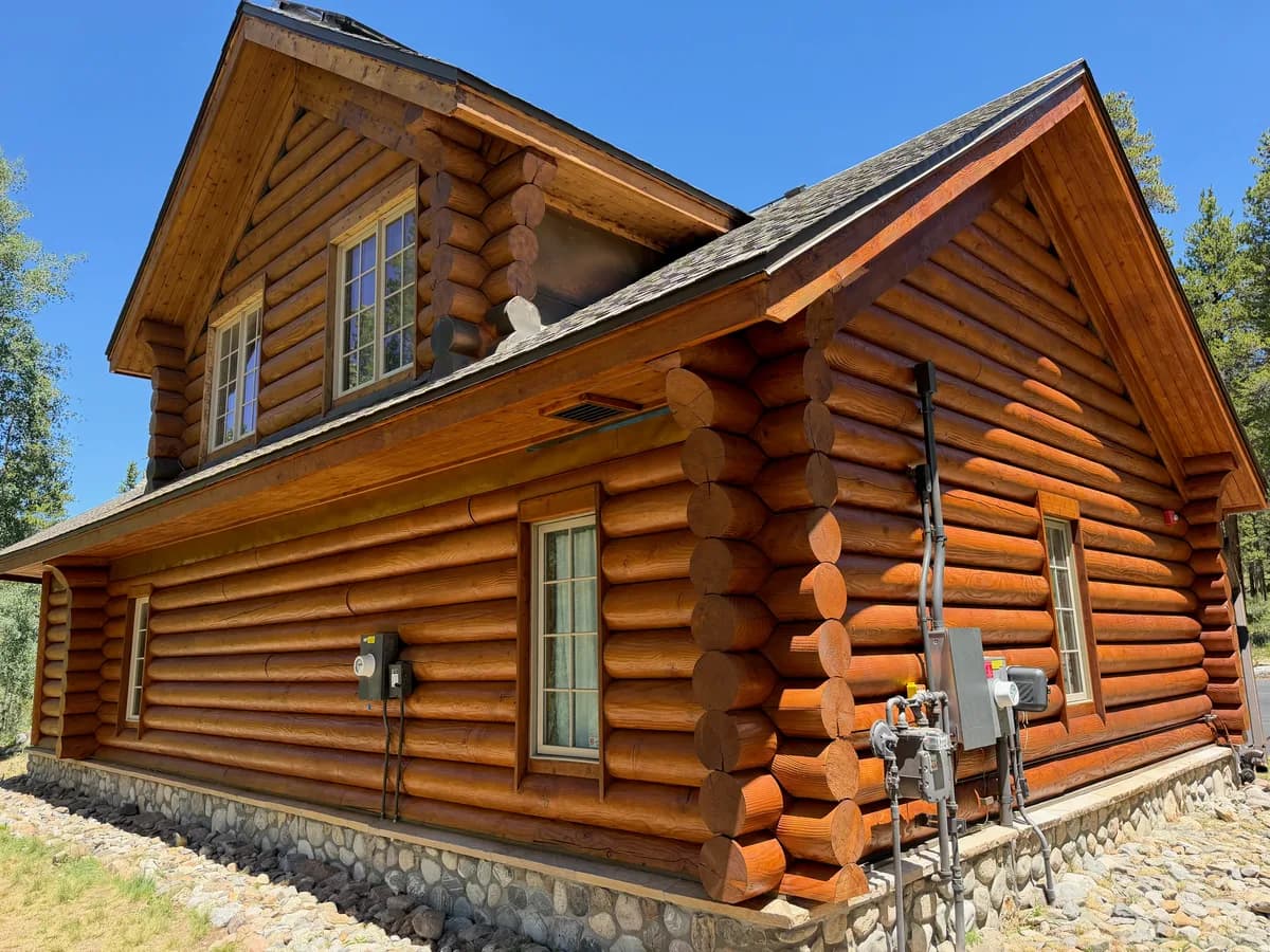 Breckenridge log home restored with Permachink Lifeline Ultra-2 Bronze stain under a clear blue Colorado sky