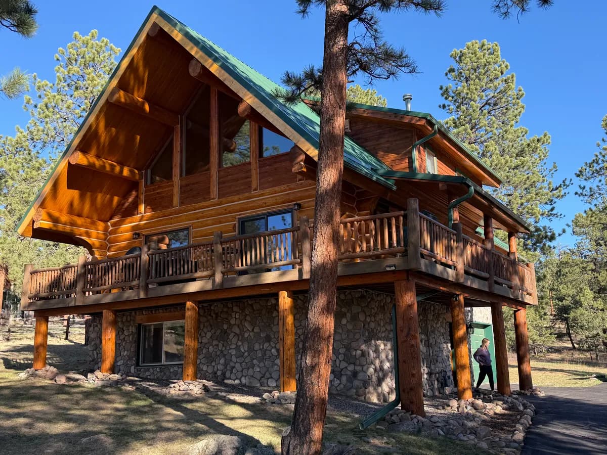 Log home after professional restoration in Bailey, Colorado - TJ's Log Home Full Restoration — Bailey, Colorado with fresh staining, sealed chinking, and restored natural beauty by Log Home Finishing LLC