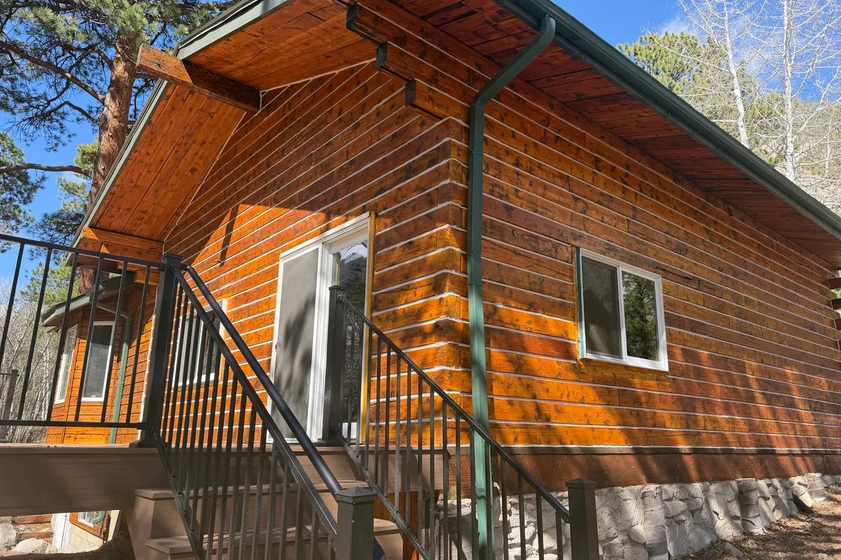 Completed log home restoration in Nathrop Colorado Chaffee County showing Sashco Transformation Goldtone Medium stain and beautiful warm golden finish